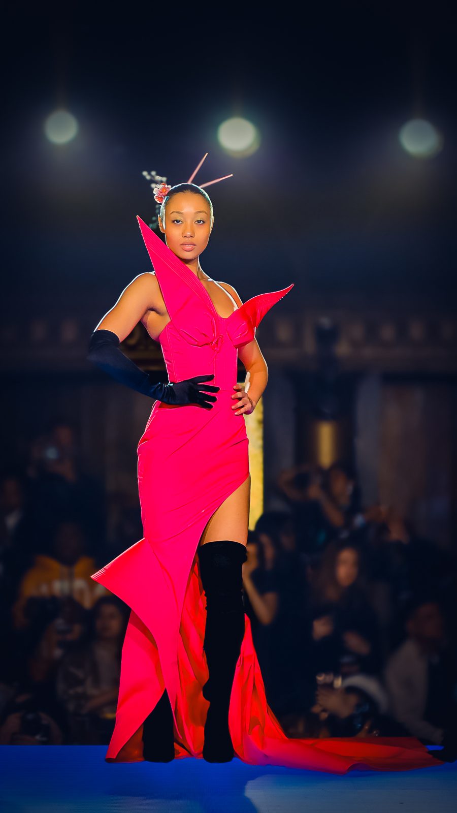 Model in a sculptural pink gown on the runway